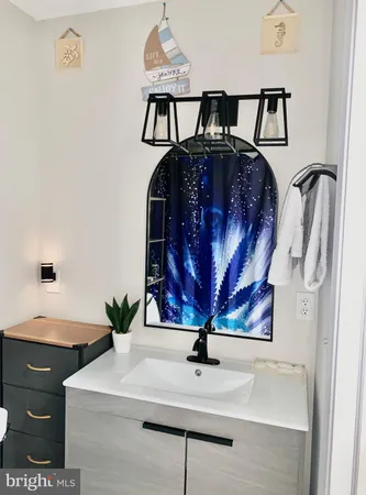 a view of a bathroom with a sink and mirror