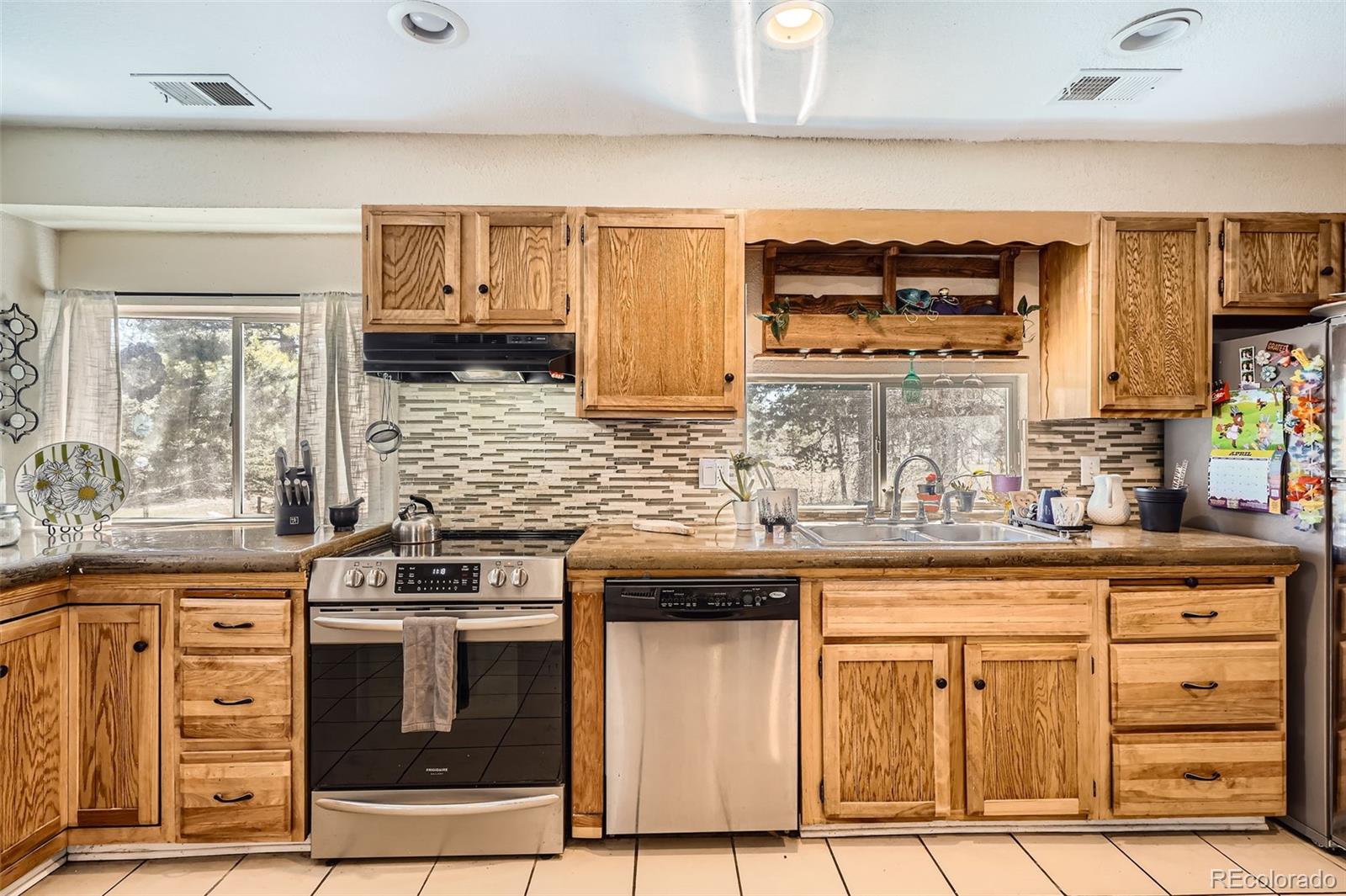 33 L Road Golden, CO 80403 - Photo 12 of 49 a kitchen with stainless steel appliances granite countertop a stove and a sink