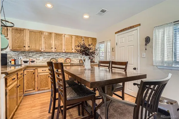a view of a a dining room with furniture window and wooden floor