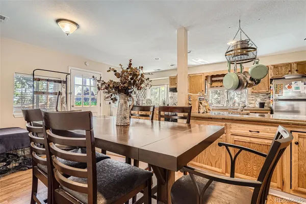 a view of a dining room with furniture and wooden floor