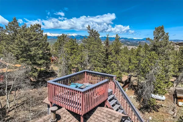 a view of a roof deck with wooden floor and city view