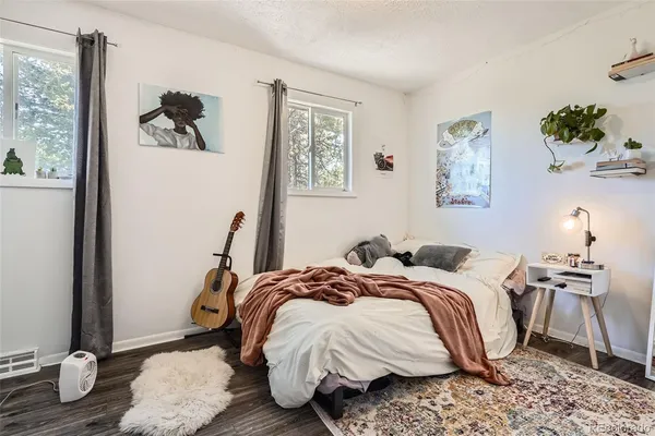 a bed sitting in a bedroom next to a window