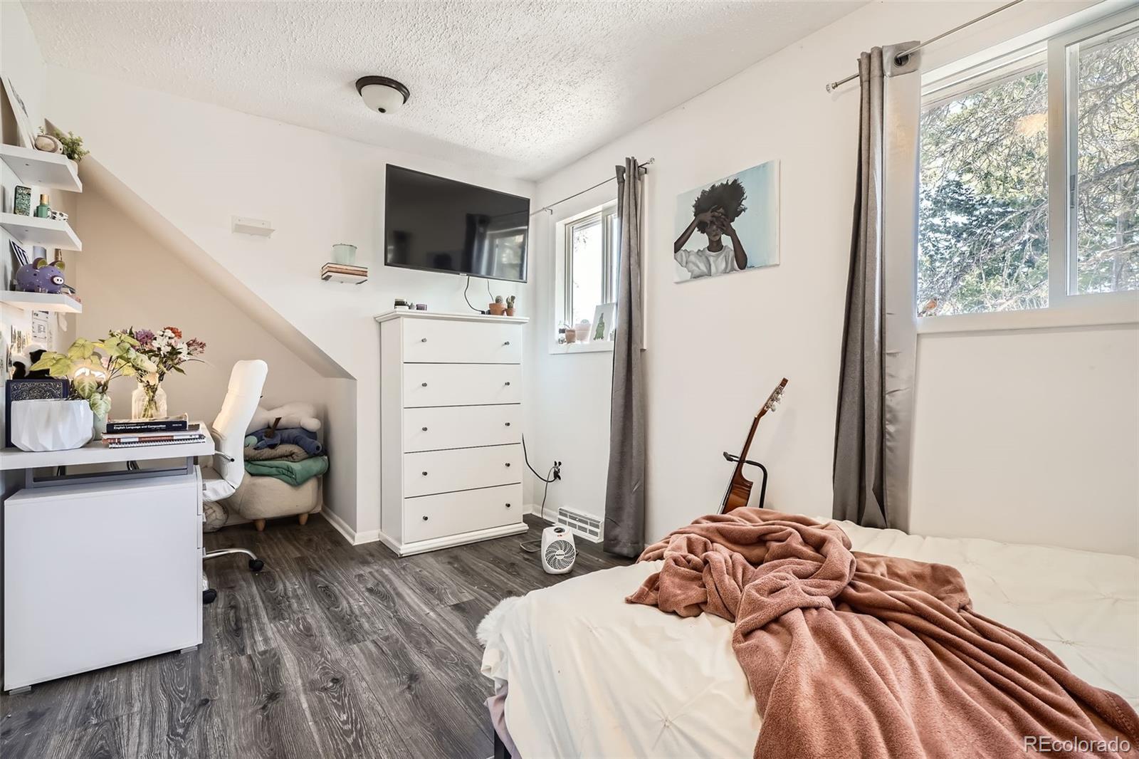 33 L Road Golden, CO 80403 - Photo 23 of 49 a bedroom with a bed and wooden floor