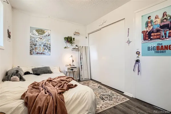 a bedroom with a bed and painting on the wall