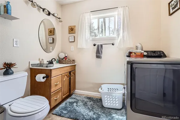 a bathroom with a toilet a sink and a mirror