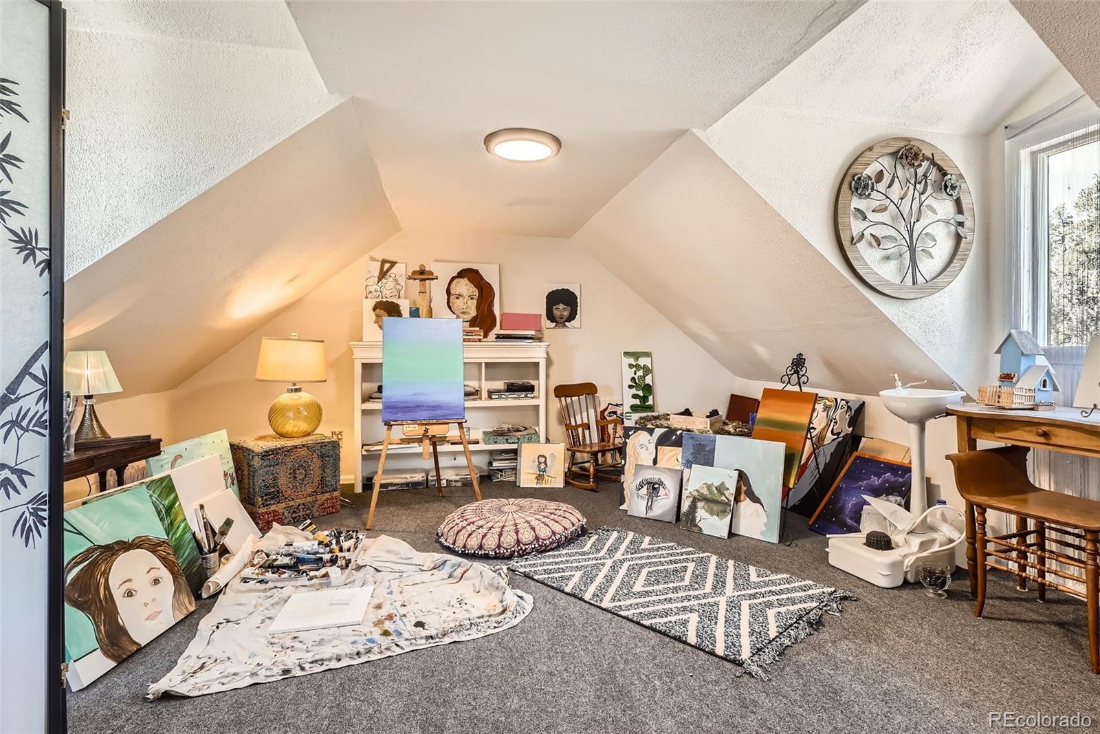 33 L Road Golden, CO 80403 - Photo 28 of 49 a living room with furniture a clock and a table