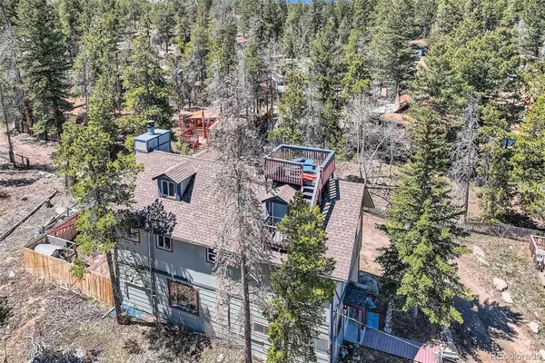 a aerial view of a house with large trees