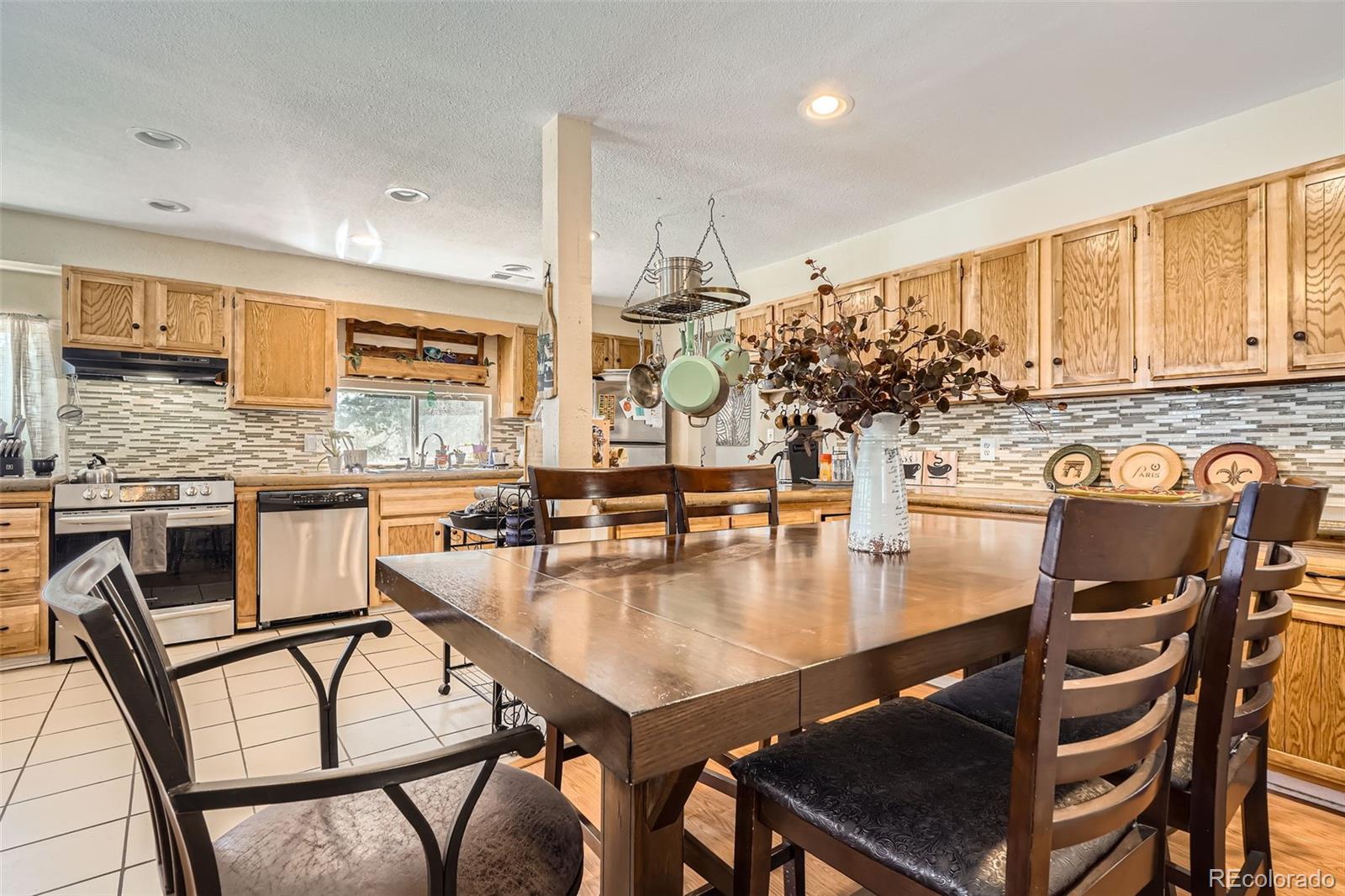 33 L Road Golden, CO 80403 - Photo 4 of 49 a kitchen with a table chairs stove and kitchen island