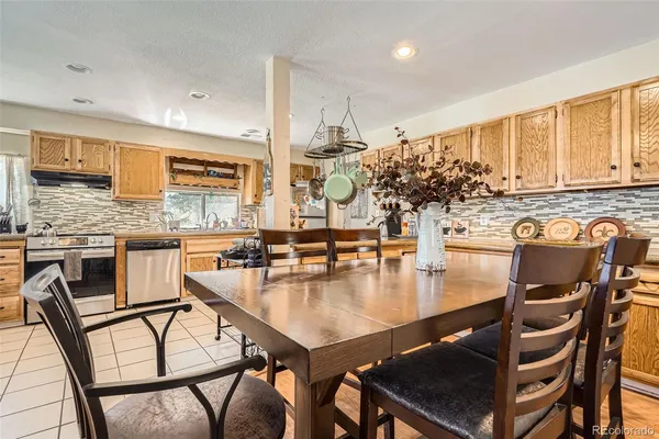 a kitchen with a table chairs stove and kitchen island