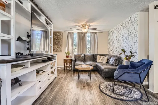 a living room with furniture fireplace and wooden floor