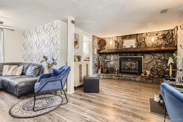 a living room with furniture a dining table and a fireplace