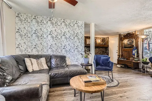 a living room with furniture and a lamp