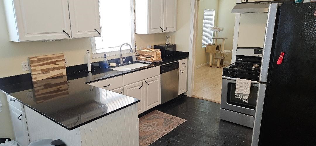 932 Walling Street Houston, TX 77009 - Photo 13 of 23 a kitchen with stainless steel appliances granite countertop a sink stove and refrigerator