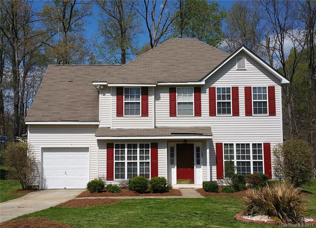 11203 Gold Pan Road Charlotte, NC 28215 - Photo 1 of 15 a front view of a house with a yard and garage
