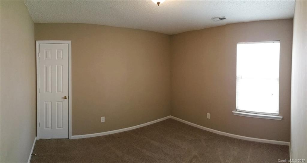 11203 Gold Pan Road Charlotte, NC 28215 - Photo 11 of 15 an empty room with a window