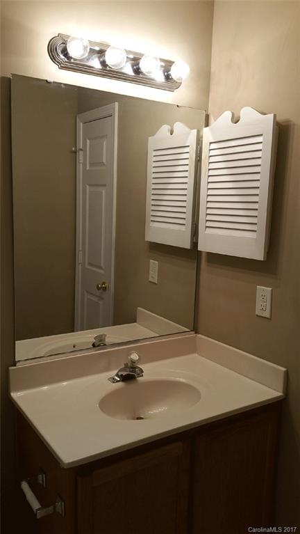 11203 Gold Pan Road Charlotte, NC 28215 - Photo 12 of 15 a bathroom with a sink and a mirror