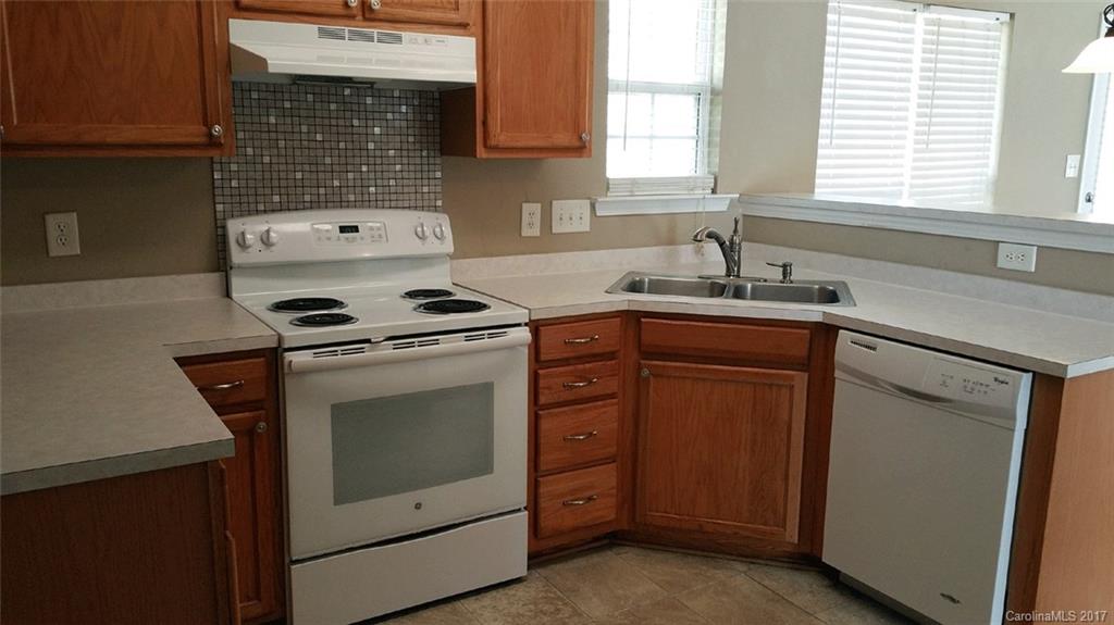 11203 Gold Pan Road Charlotte, NC 28215 - Photo 4 of 15 a kitchen with appliances cabinets and a sink