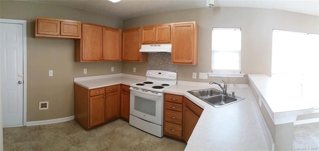 11203 Gold Pan Road Charlotte, NC 28215 - Photo 5 of 15 a kitchen with a sink and a stove