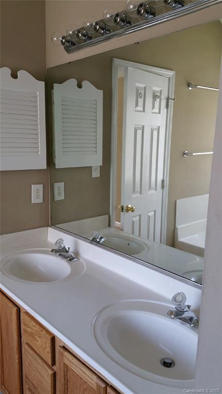 11203 Gold Pan Road Charlotte, NC 28215 - Photo 9 of 15 a bathroom with a sink and a mirror