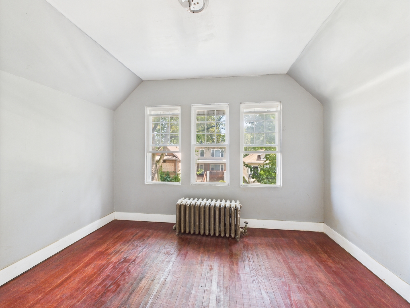 11922 South Perry Avenue Chicago, IL 60628 - Photo 15 of 23 an empty room with wooden floor and windows