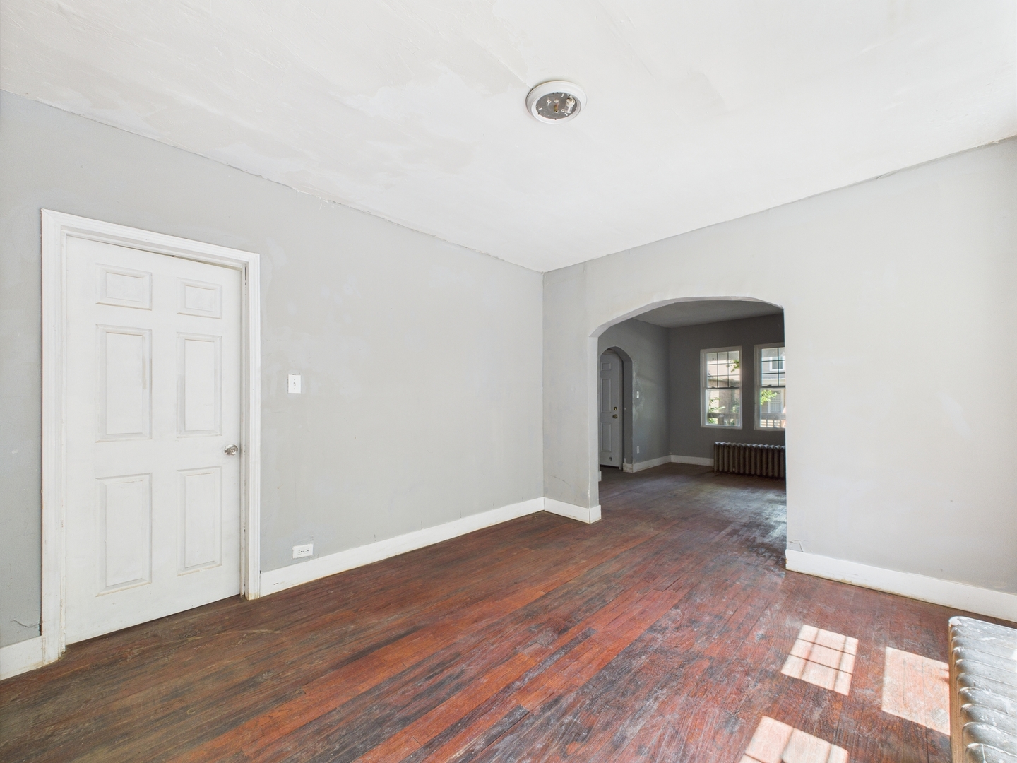 11922 South Perry Avenue Chicago, IL 60628 - Photo 7 of 23 an empty room with wooden floor and closet