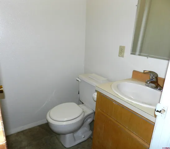 a white toilet sitting next to a sink