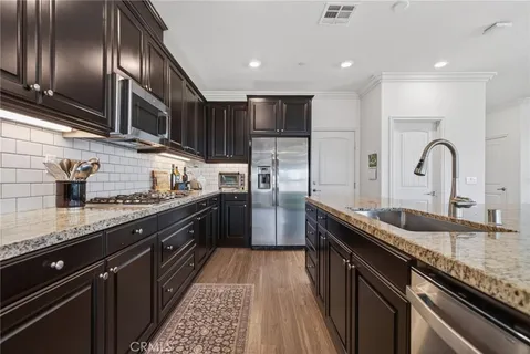 a living room with furniture and kitchen view