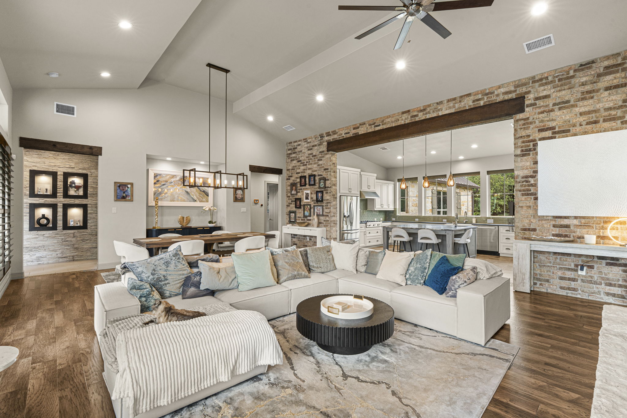 16202 Remuda Trail Buda, TX 78610 - Photo 5 of 40 Spacious living area featuring vaulted ceilings, recessed lighting, and hardwood flooring