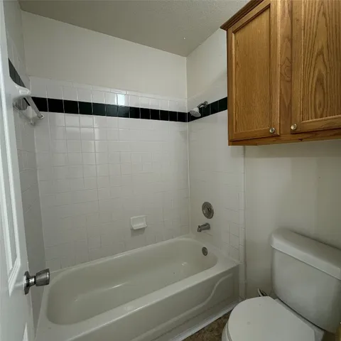 a bathroom with a shower curtain and a toilet