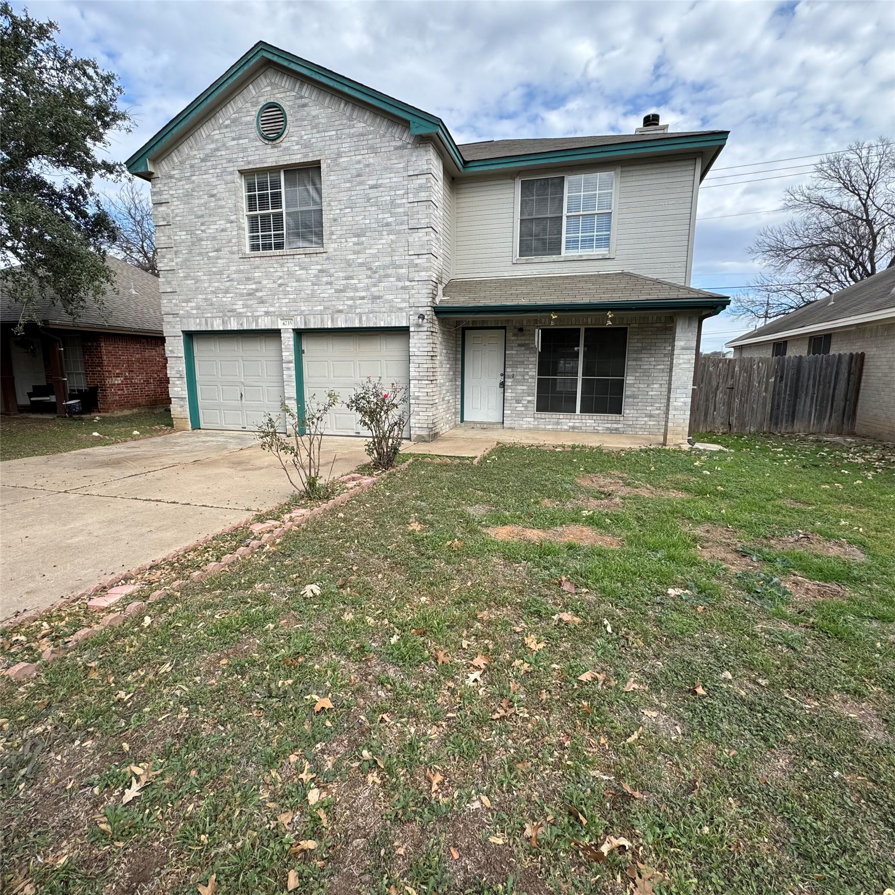 4735 Castleman Drive Austin, TX 78724 - Photo 2 of 16 Traditional home with brick siding, an attached garage, and concrete driveway