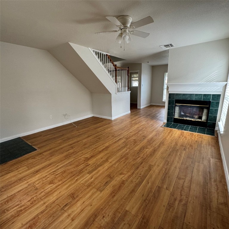 4735 Castleman Drive Austin, TX 78724 - Photo 2 of 16 wooden floor fireplace and windows in an empty room