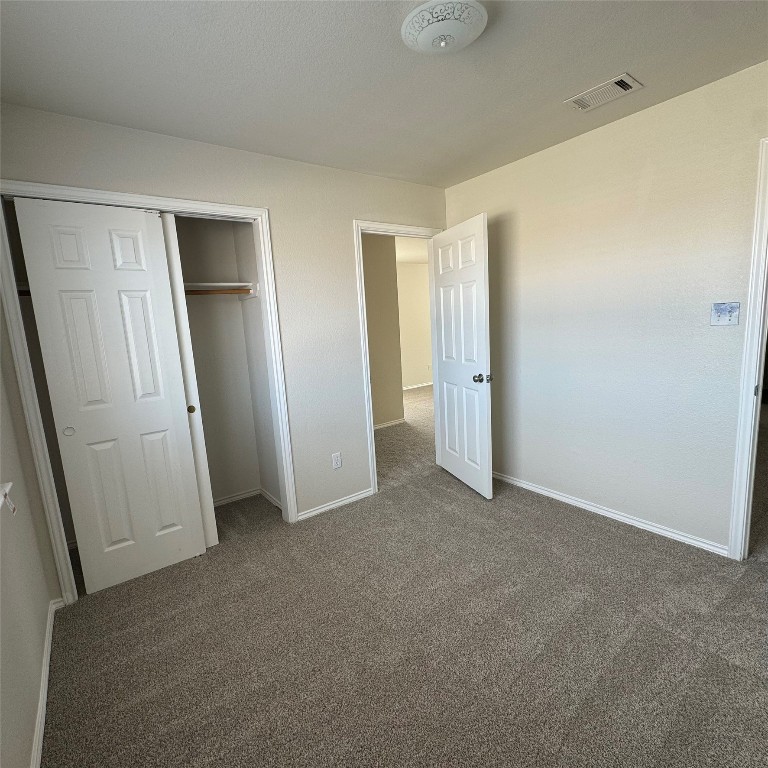 4735 Castleman Drive Austin, TX 78724 - Photo 10 of 16 an empty room with closet and mirror