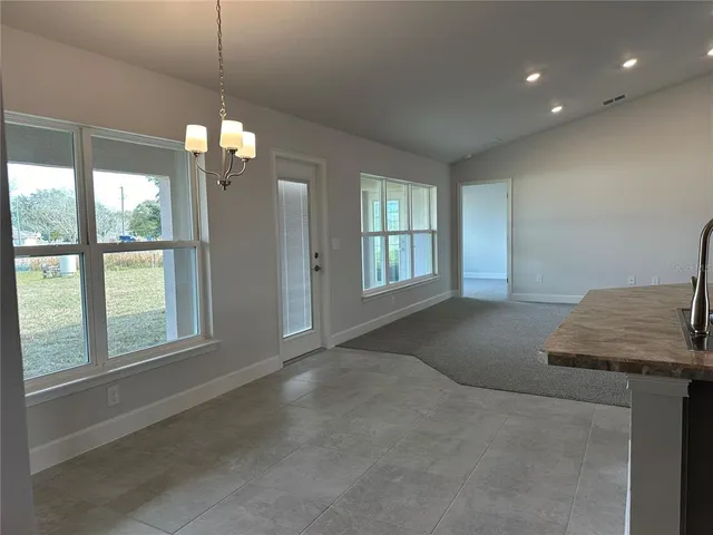 a view of a livingroom with a ceiling fan and window