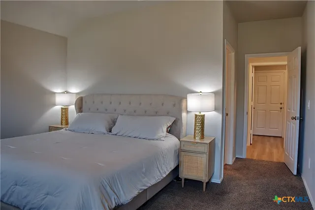 a bedroom with a bed and a lamp