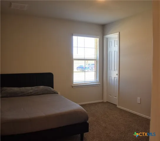 a bedroom with a bed and window