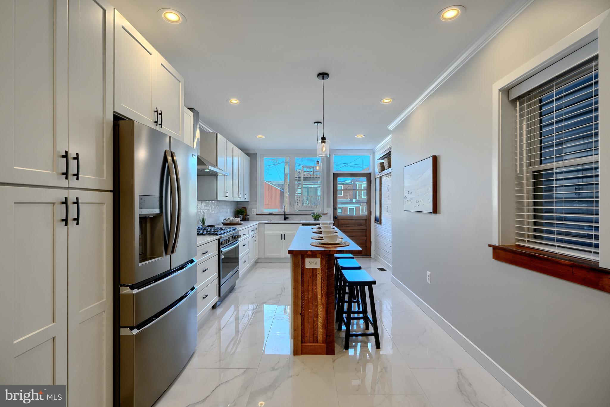 1435 Riverside Avenue Baltimore, MD 21230 - Photo 16 of 78 a kitchen with stainless steel appliances kitchen island granite countertop a refrigerator oven a sink dishwasher and a stove with wooden floor
