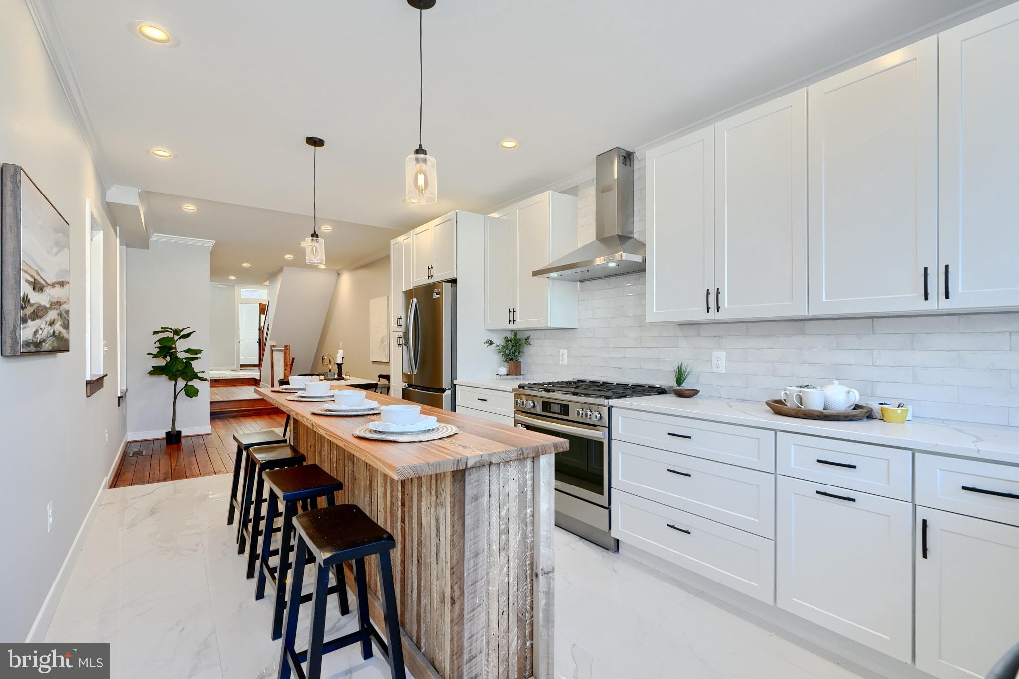 1435 Riverside Avenue Baltimore, MD 21230 - Photo 20 of 78 a kitchen with stainless steel appliances kitchen island wooden cabinets and white appliances