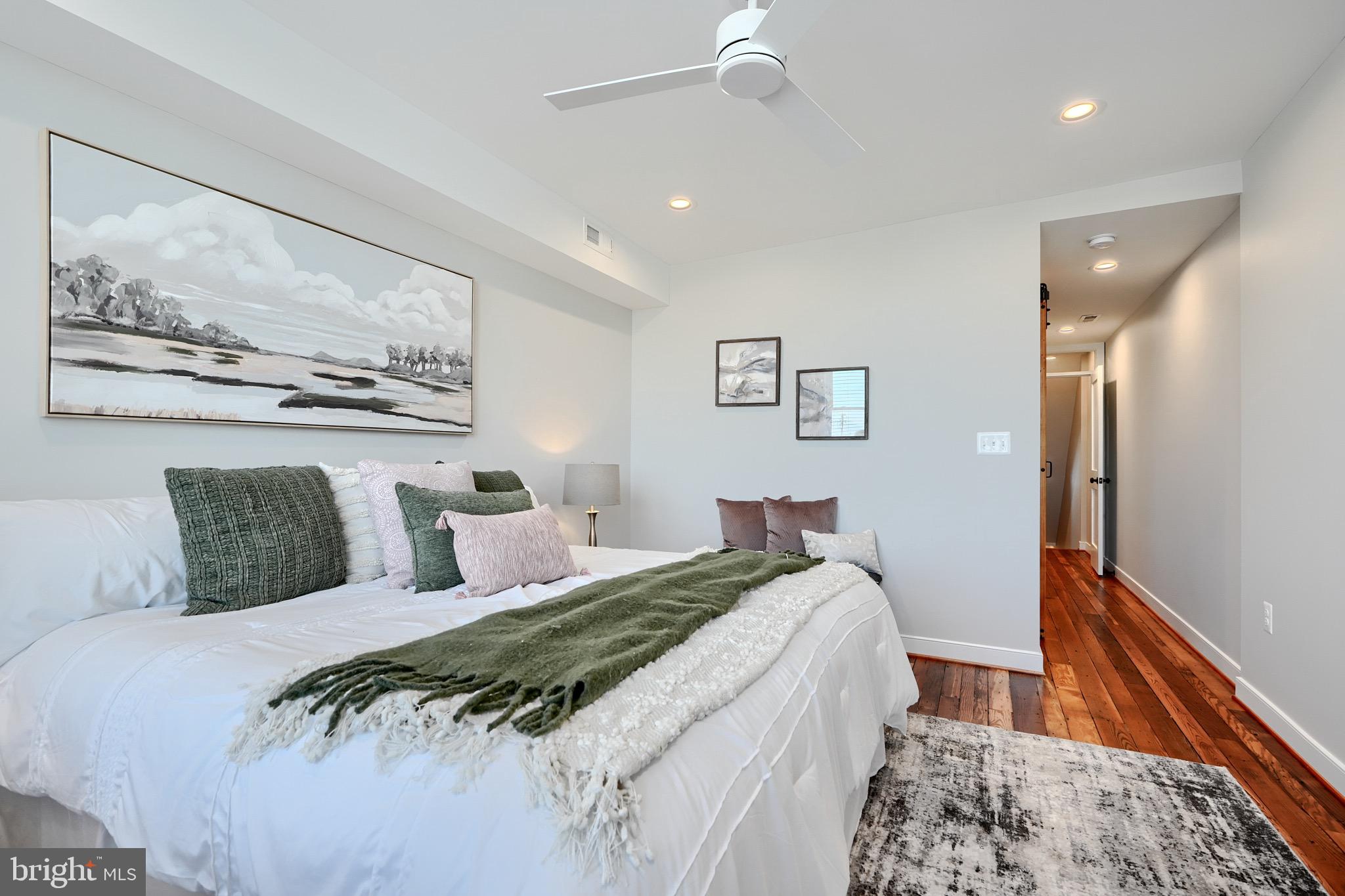 1435 Riverside Avenue Baltimore, MD 21230 - Photo 36 of 78 a bed room with a bed and a painting on the wall