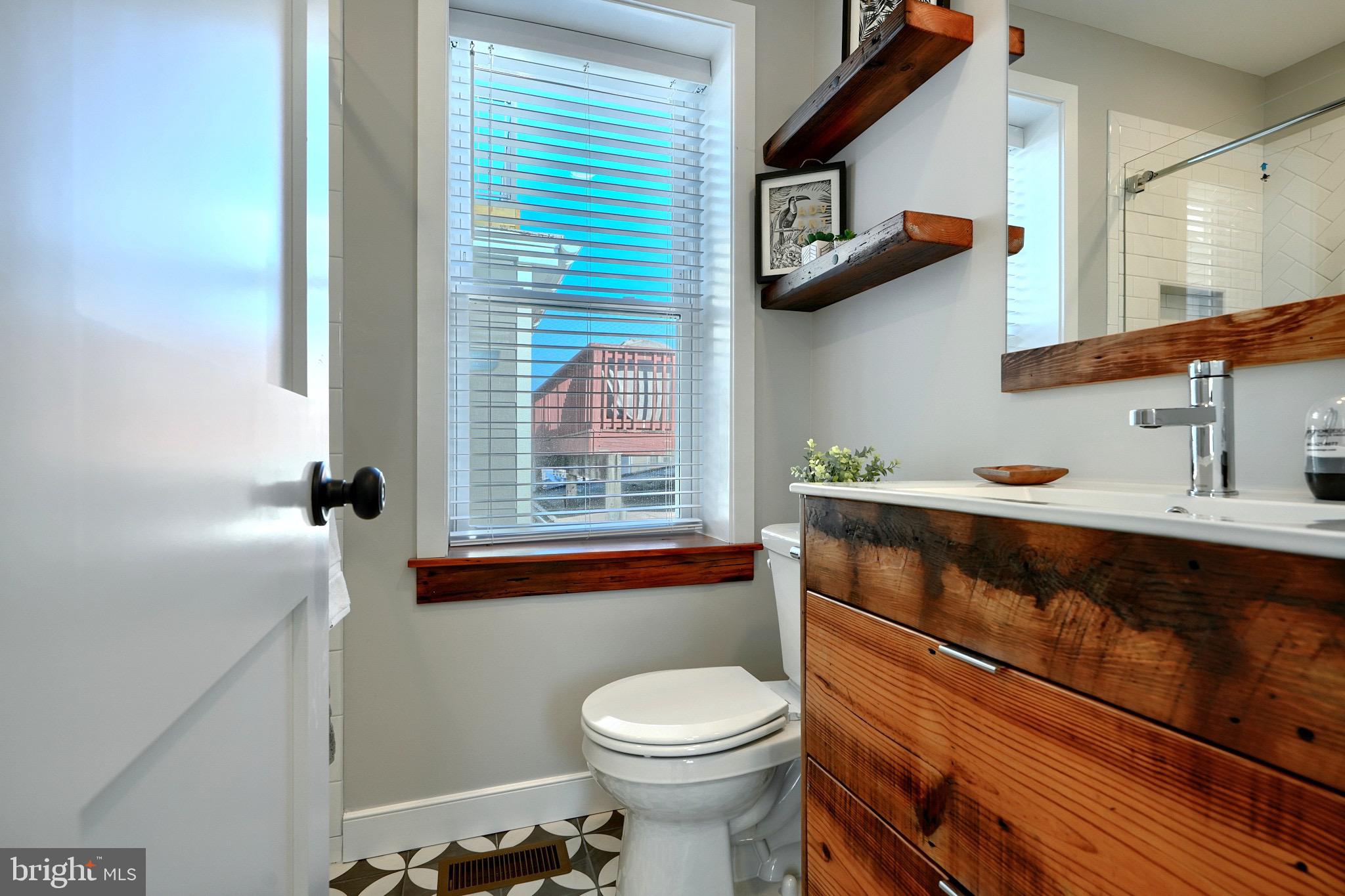 1435 Riverside Avenue Baltimore, MD 21230 - Photo 45 of 78 a bathroom with a toilet a sink and a window