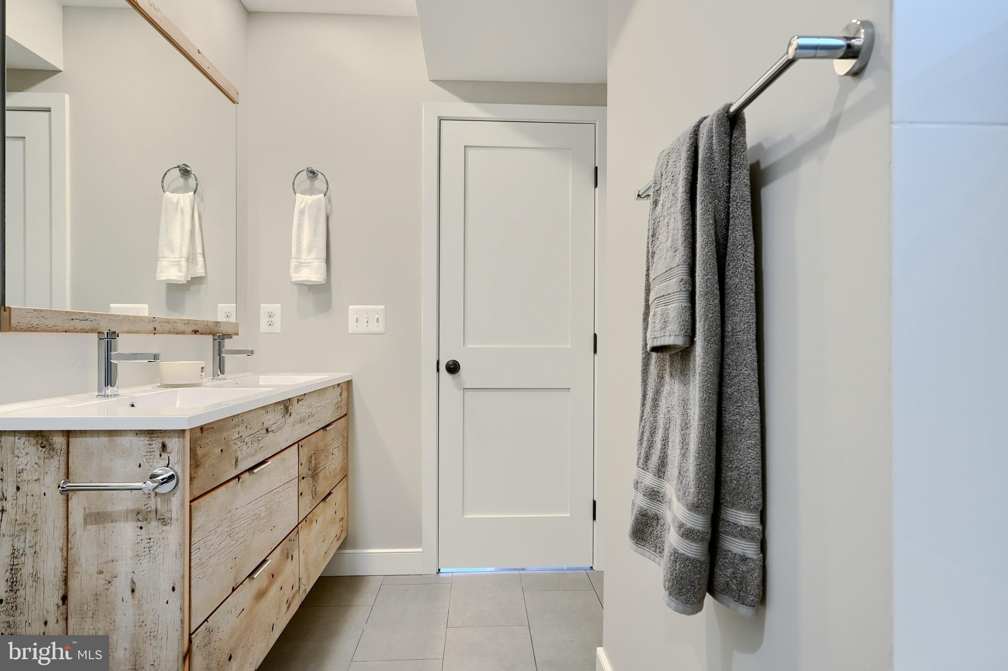 1435 Riverside Avenue Baltimore, MD 21230 - Photo 52 of 78 a bathroom with a sink a mirror and a shower