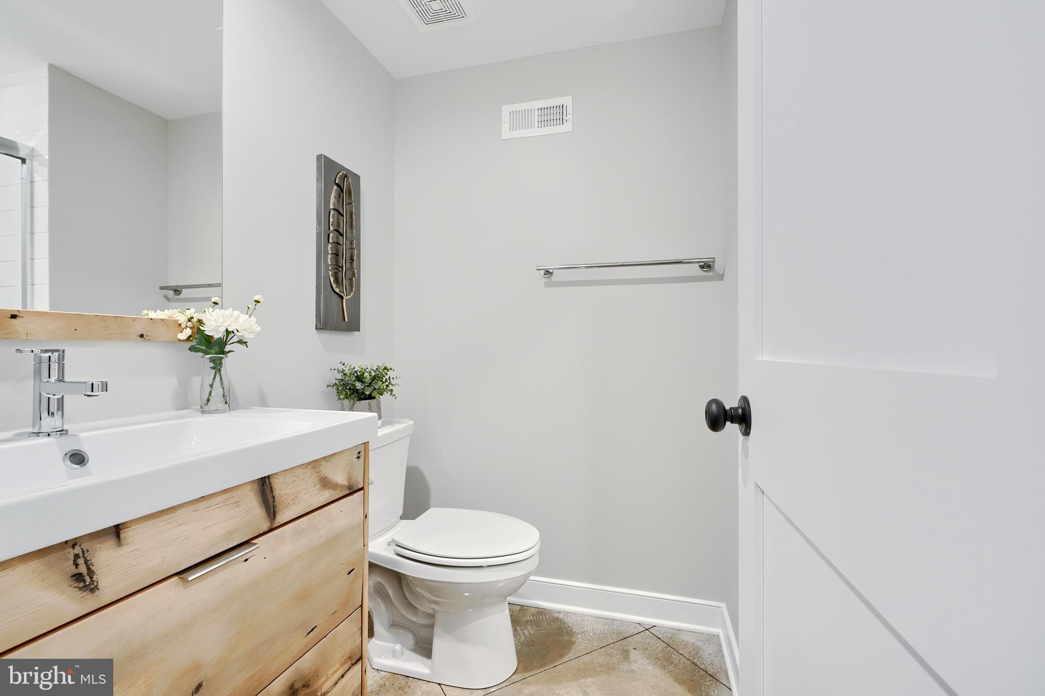 1435 Riverside Avenue Baltimore, MD 21230 - Photo 65 of 78 a bathroom with a white toilet sitting next to a bathroom sink