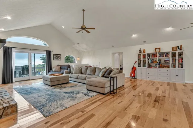 a living room with fireplace furniture and a view of kitchen