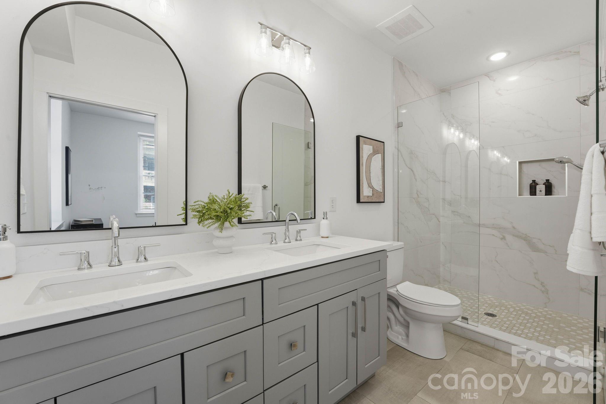 201 Grandin Road, Unit 6 Charlotte, NC 28208 - Photo 13 of 45 a bathroom with a double vanity sink toilet and shower