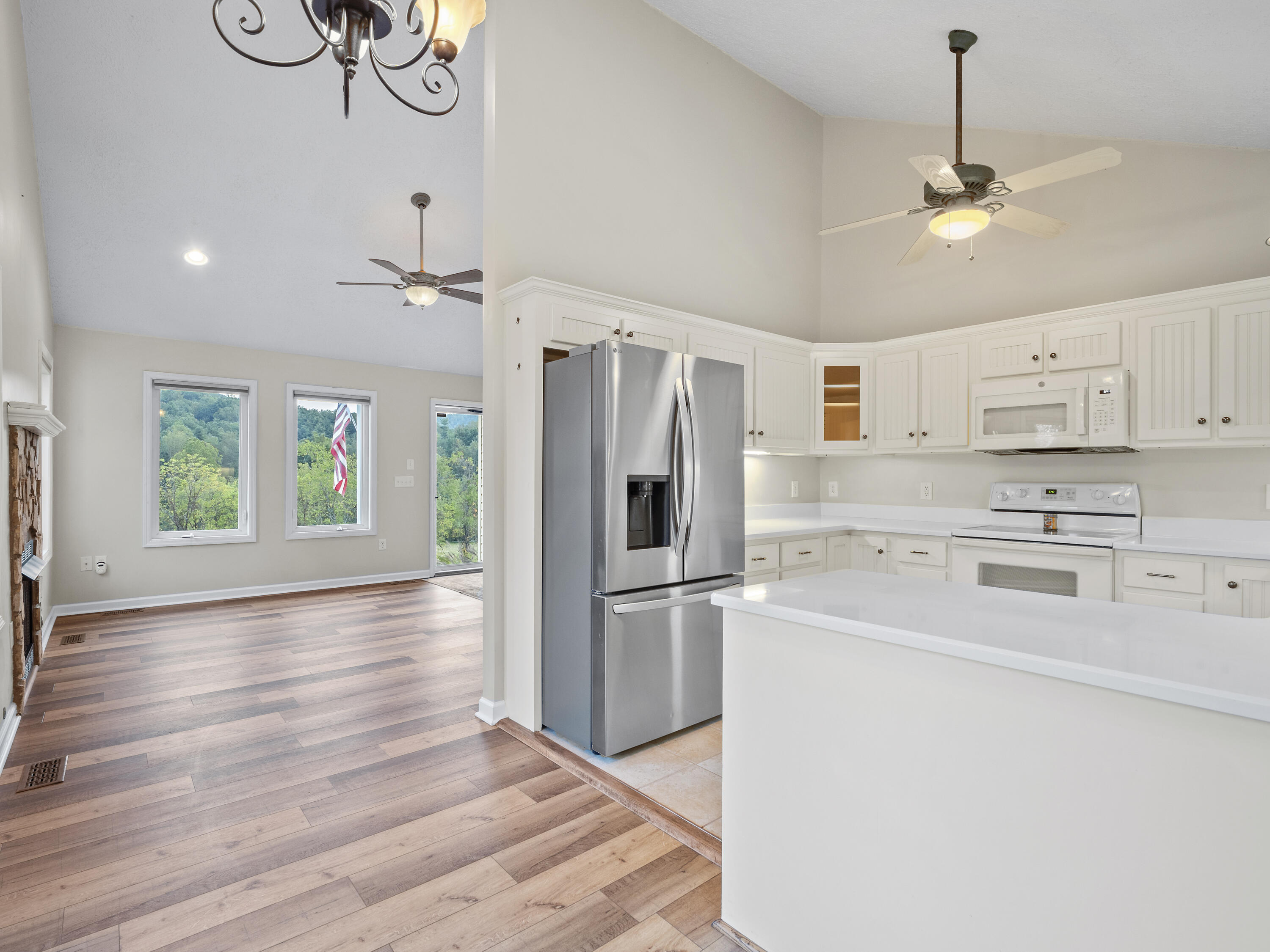 885 Whetstone Road Ferrum, VA 24088 - Photo 11 of 64 a kitchen with a refrigerator stove and white cabinets