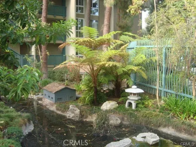 a view of backyard of house with green space
