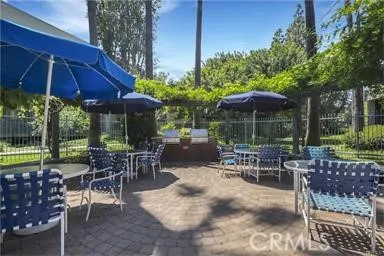 a patio with a table and chairs under an umbrella
