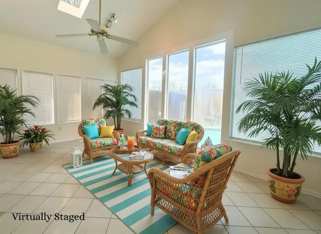 a view of an empty room and a ceiling fan