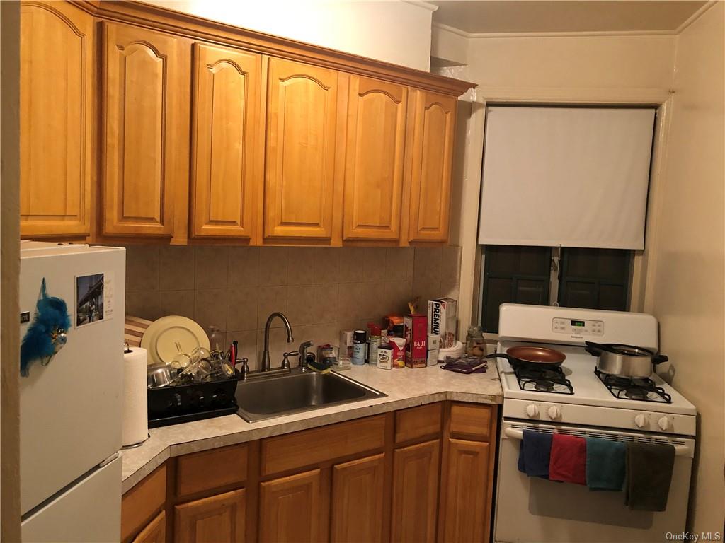 a kitchen with stainless steel appliances a sink a stove and a refrigerator