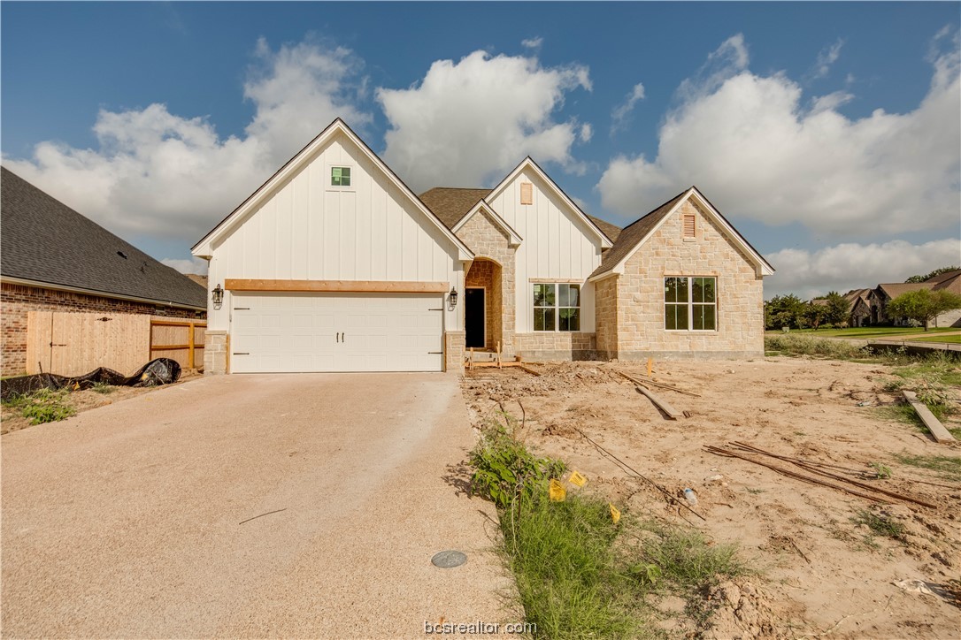 a view of a house with a yard and garage