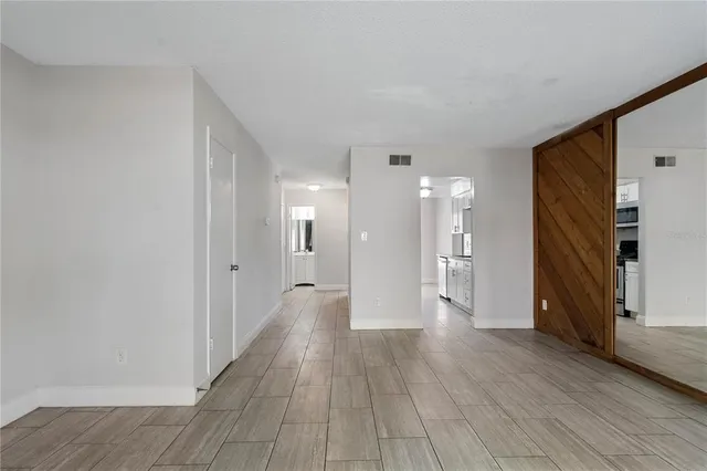 a view of a hallway with wooden floor